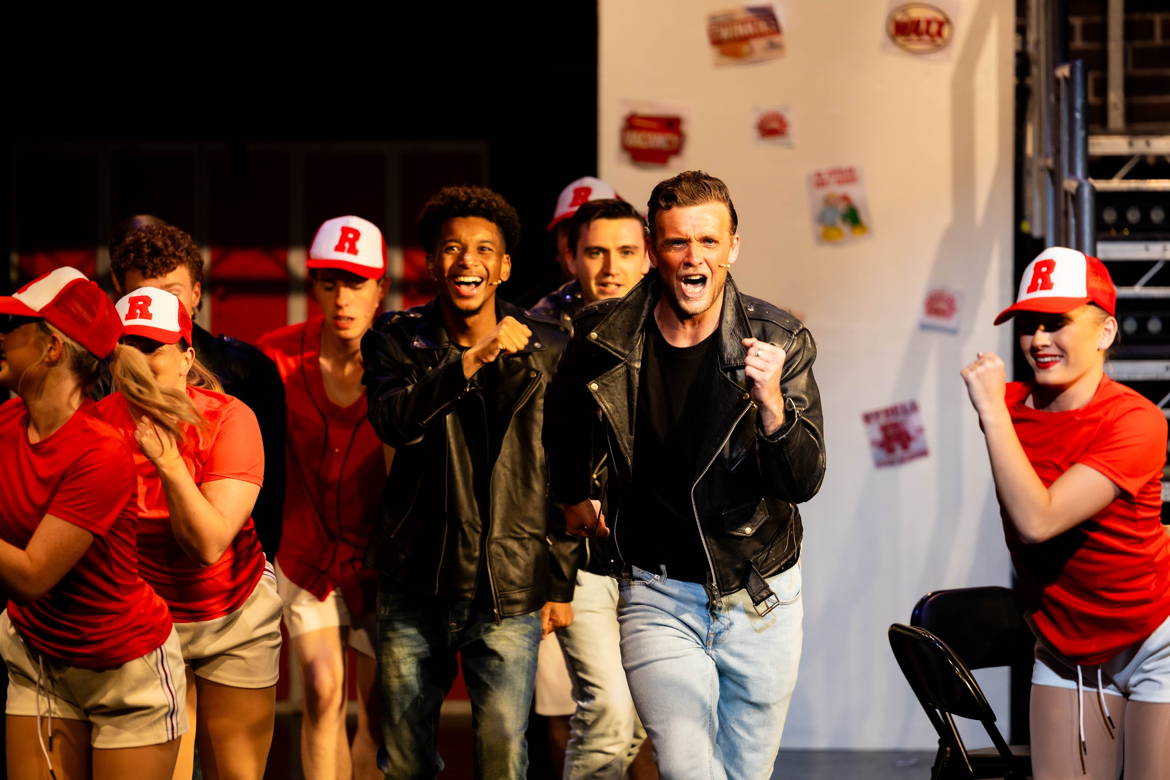 Danny Zuko and Doody pose during a song. They are surrounded by the other T-Birds and the Principal Dancers.